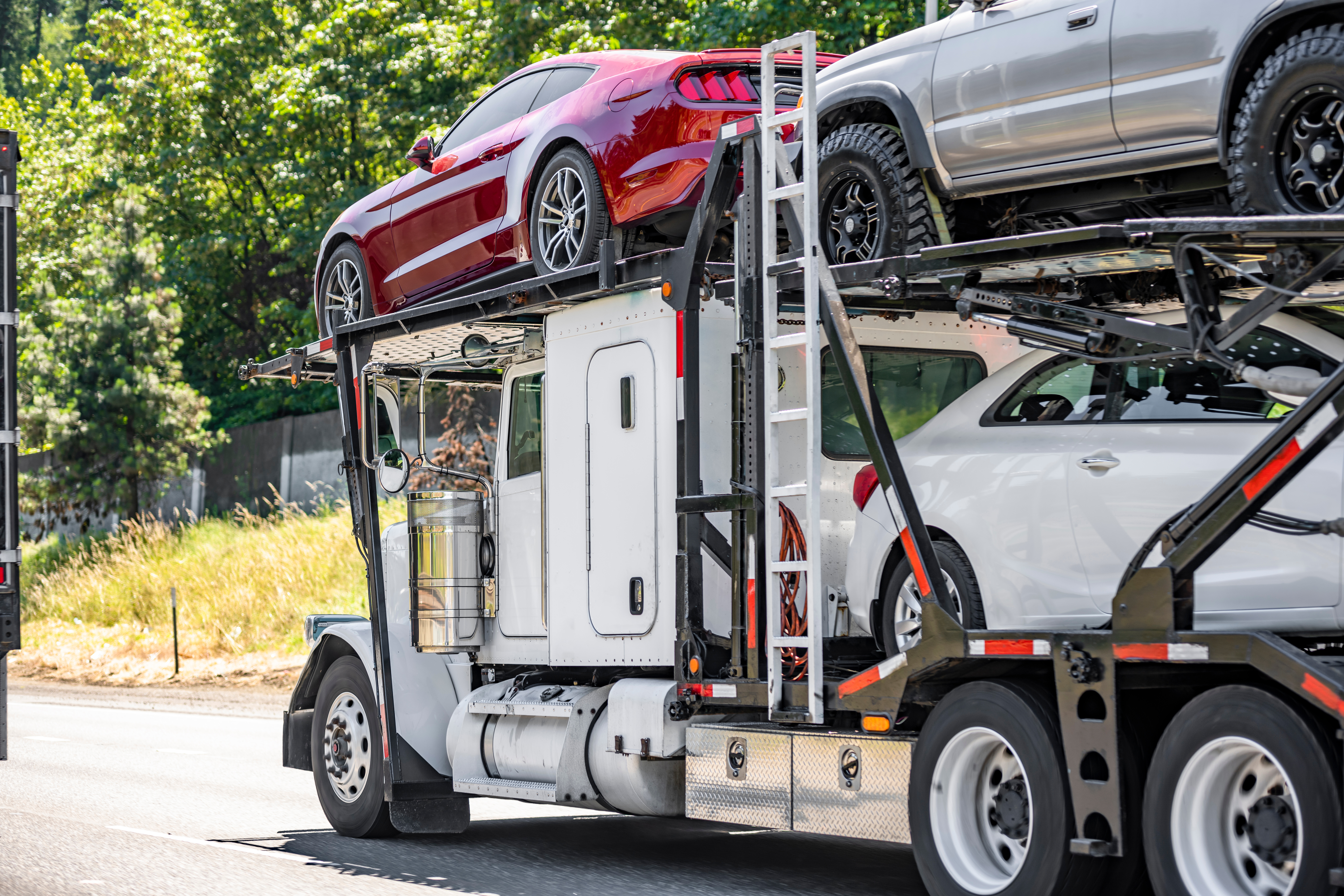 Industrial car hauler driving on the road