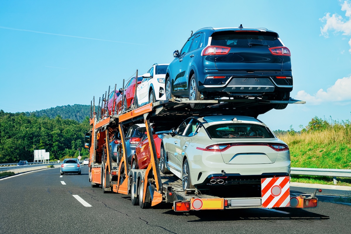 Cars carrier truck on the asphalt highway in Poland. Truck transporter